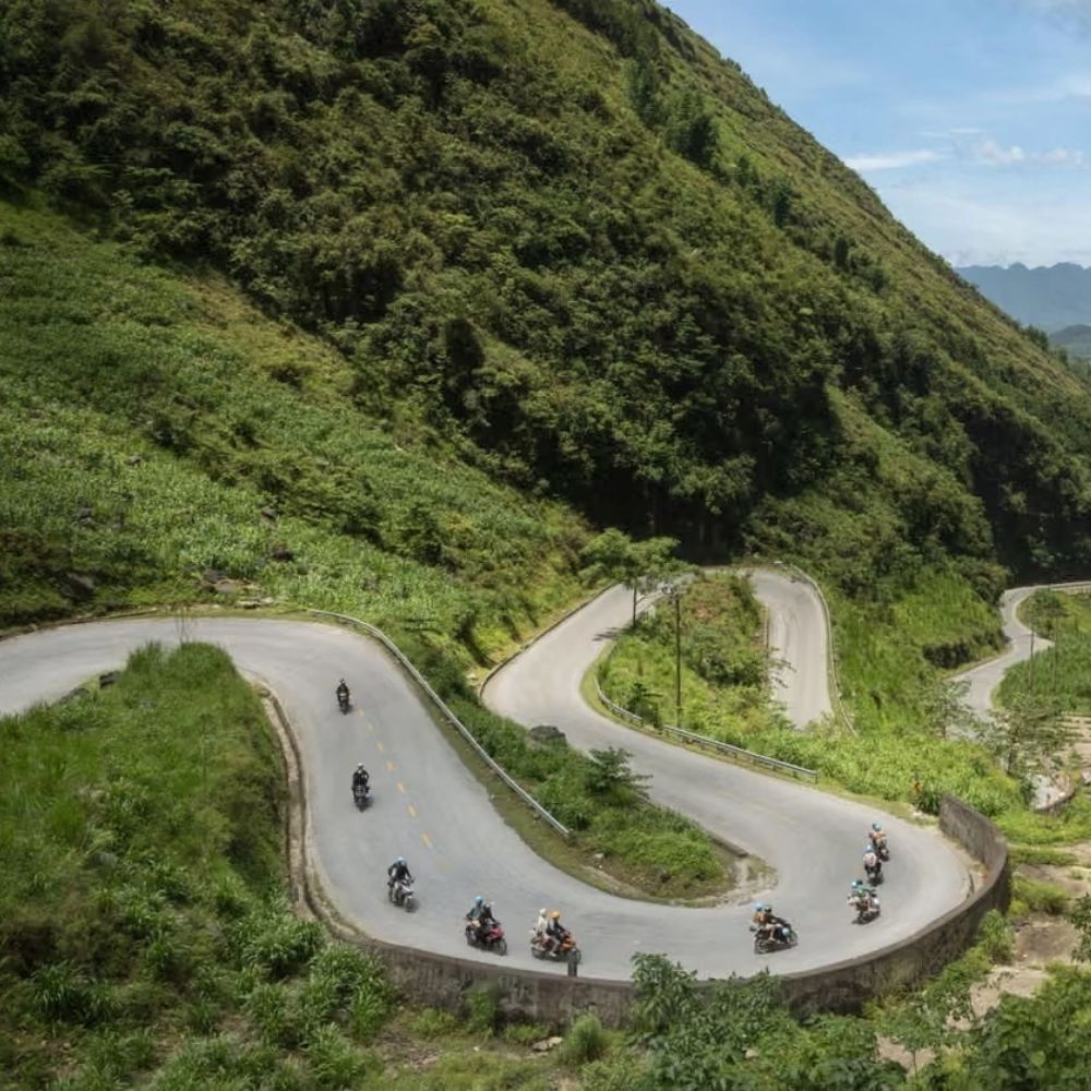 Motorbike riders facing the dust factor constraint during a group tour, compared to private vs group Ha Giang Loop tours choices