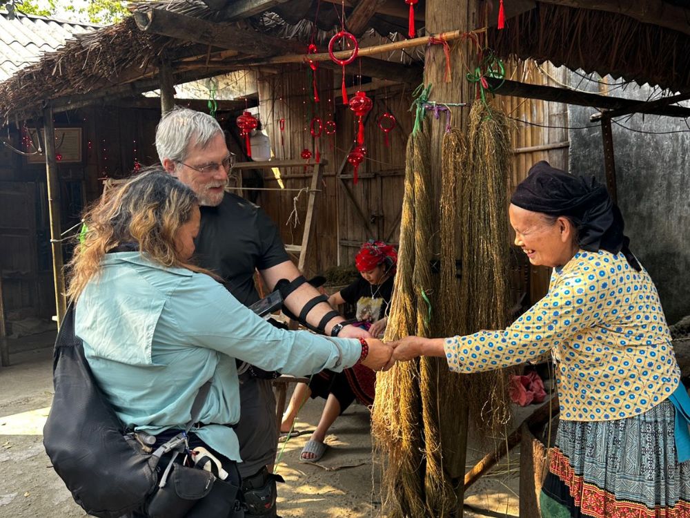 Tourist interacting with local people Ha Giang Loop itinerary for seniors