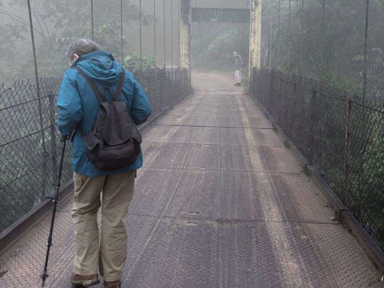 Backpacker walking on a quiet road away from Dao Ao Dai Villages