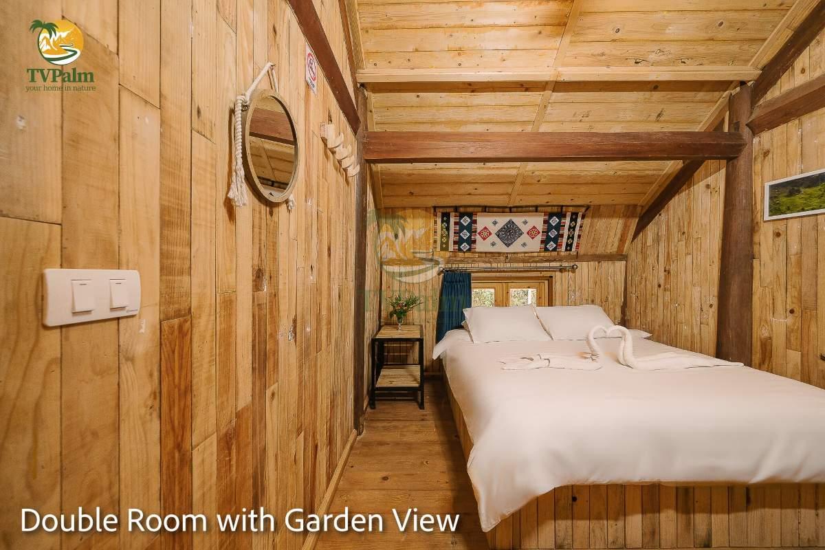 Double Room with Garden View in Ha Giang at TVPalm featuring cozy wooden interior and double bed
