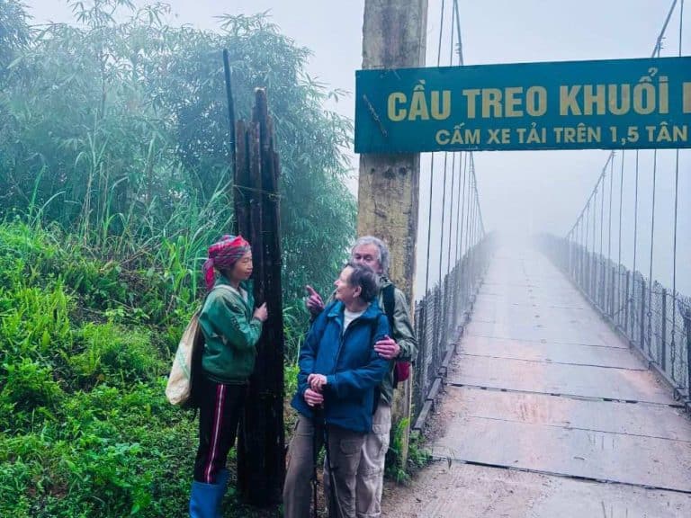 Group of trekkers at the entrance gate of Dao Ao Dai Villages