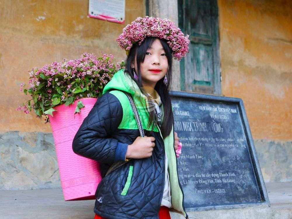 Local girl with flower basket on Ha Giang loop 2 days trip