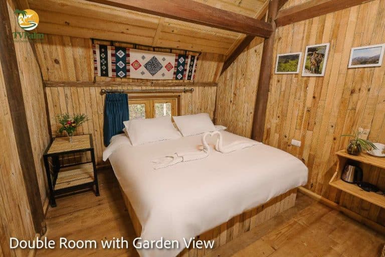 Spacious Double Room with Garden View in Ha Giang featuring comfortable double bed and wooden décor