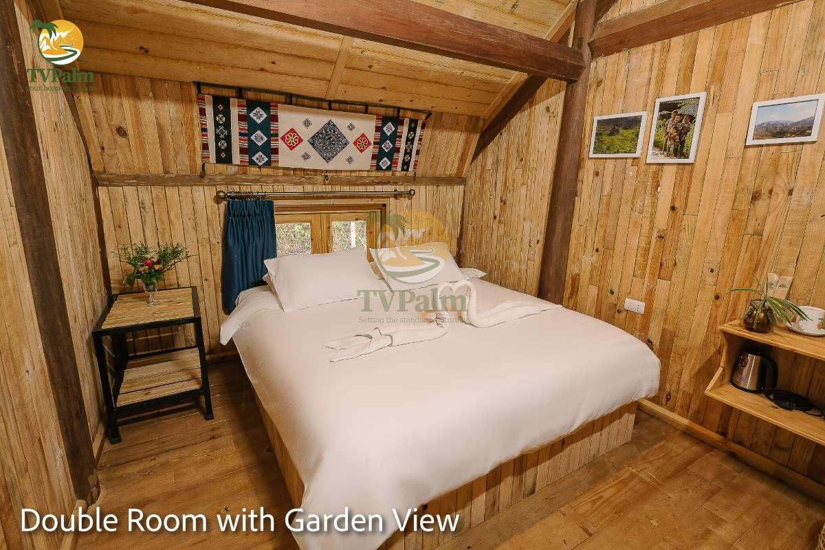 Spacious Double Room with Garden View in Ha Giang featuring comfortable double bed and wooden décor