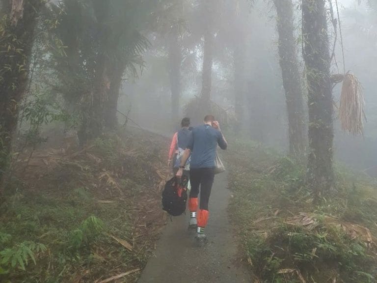 Trekking through a foggy mountain path on 1 day ancient snow shan tea tour