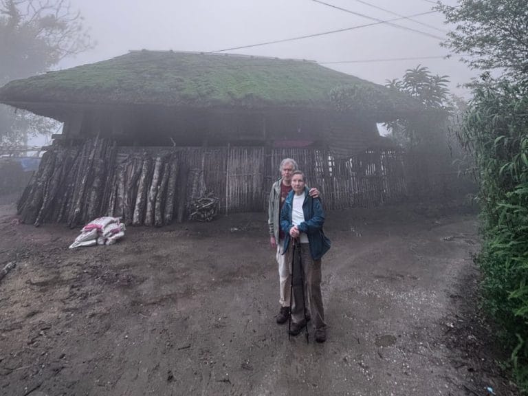 Two tourists exploring the misty Dao Ao Dai Villages landscape