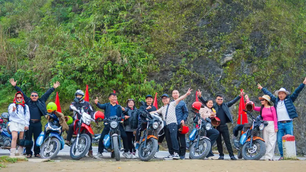 Motorcyclists and Easy Rider tour guides gathered with bikes along the mountain pass route between Ha Giang and Cao Bang