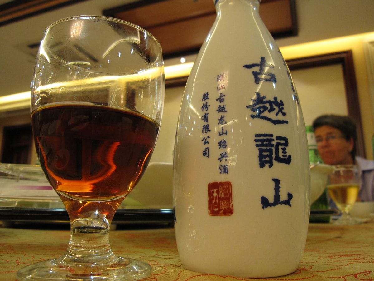 Clear mountain corn wine Ruou Ngo served in small ceramic cups in Ha Giang homestay