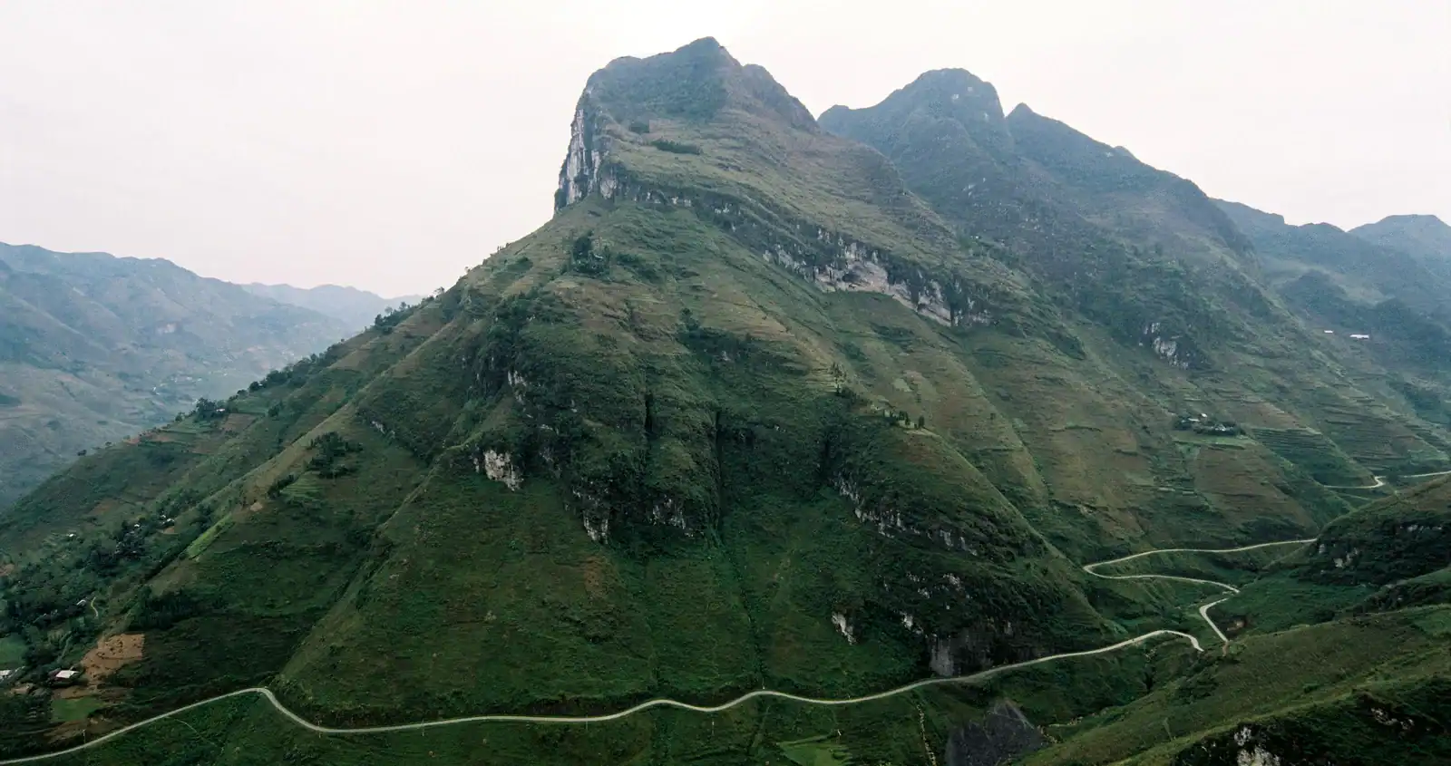 Ha Giang Loop in January scenic winding mountain road at Ma Pi Leng Pass with cool winter skies