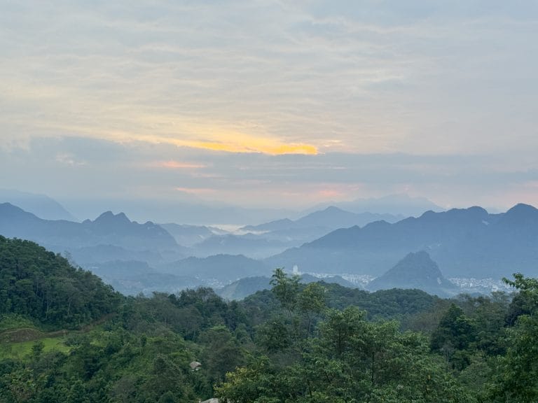 First light and mist over the valley towards Ha Giang city, seen from Xa Phin on the Tay Con Linh trek