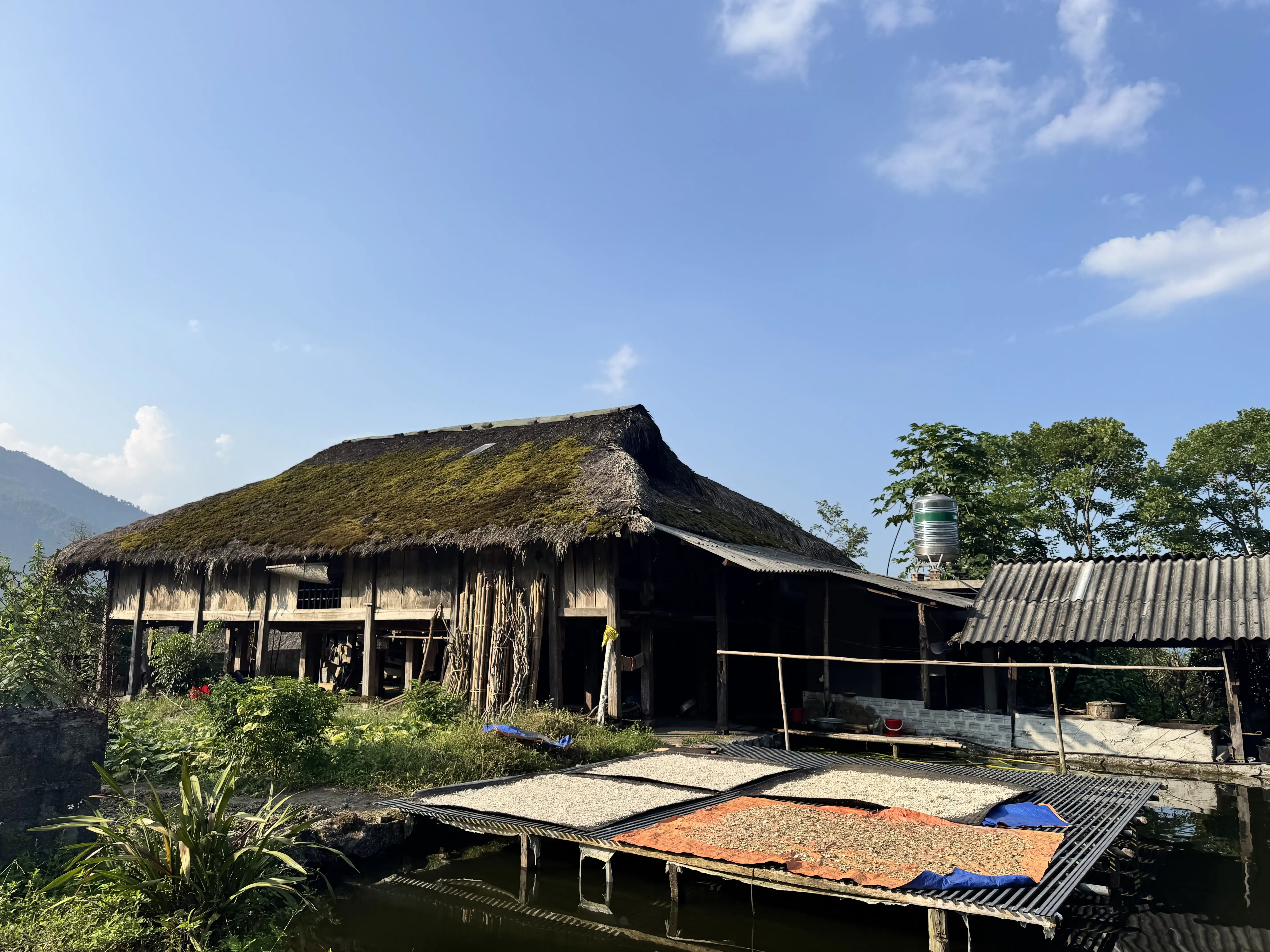 Tourists resting in traditional wooden stilt house in Ha Giang village