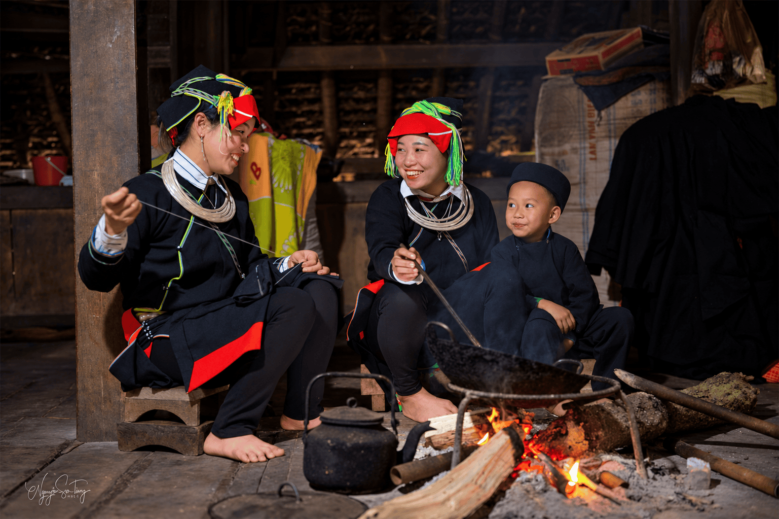 Dao Ao Dai women and a child around the fire