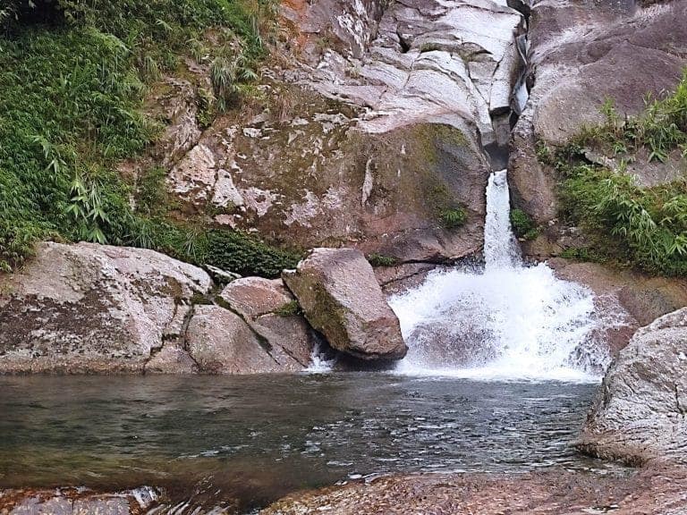 Lung Vai Waterfall dropping through a narrow granite chute
