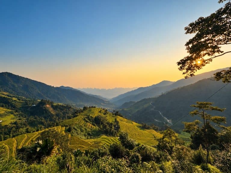 Sunset over rice terraces and the valley below Tay Con Linh
