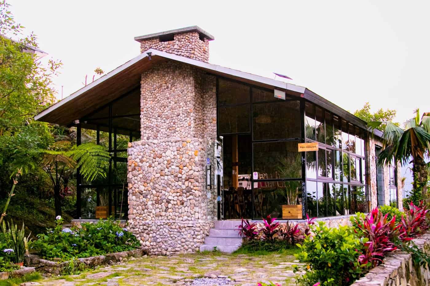 Phòng nghỉ TVPalm Ecolodge Hà Giang 11 Ống khói lò sưởi ốp đá cuội bên ngoài nhà hàng The Palm Restaurant tại TVPalm Ecolodge