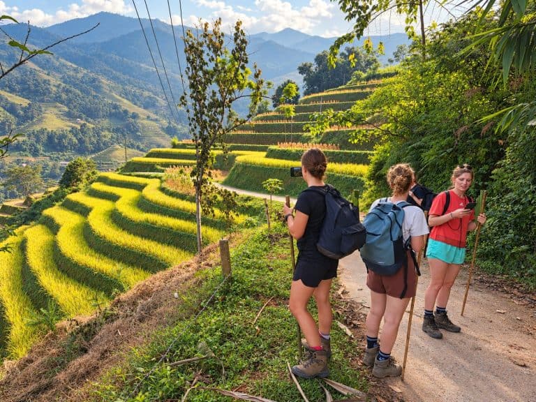 Trekkers taking photos of the rice terraces from the trail