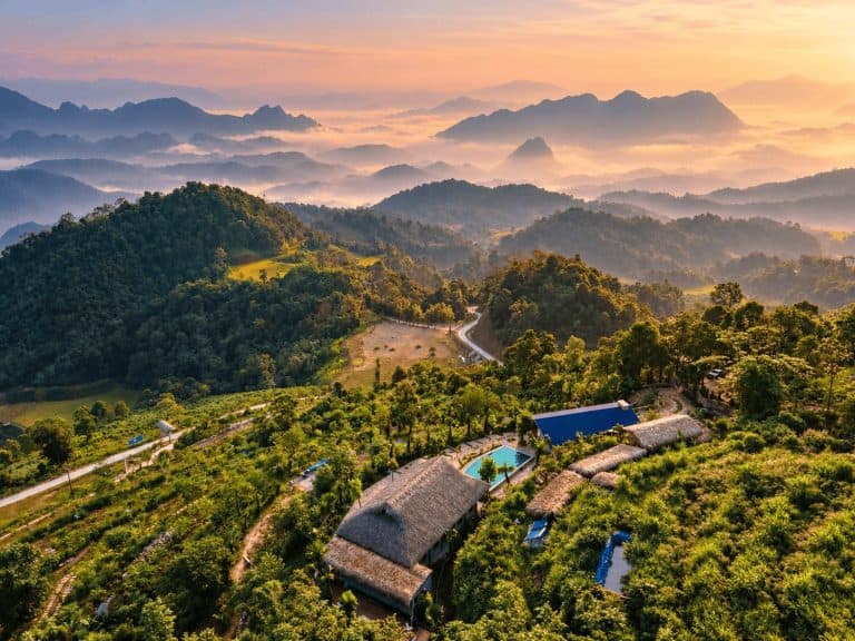 Aerial view of TVPalm Ecolodge at sunrise above the clouds, Tay Con Linh