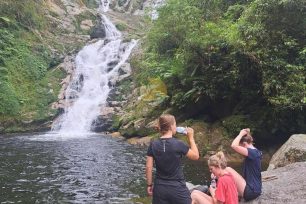 Relaxing by the waterfall on a 3-Day Tay Con Linh trekking trip