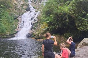 Relaxing by the waterfall on a 3-Day Tay Con Linh trekking trip
