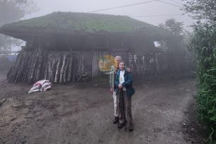 Two tourists exploring the misty Dao Ao Dai Villages landscape