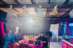 Visitors enjoying a meal and conversation inside a Dao Ao Dai Villages homestay