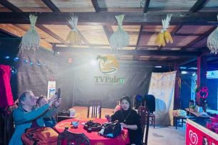 Visitors enjoying a meal and conversation inside a Dao Ao Dai Villages homestay
